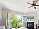 Inviting living room boasts a fireplace, ceiling fan, and balcony with scenic views at 351 Washington Ne Ave # 205, Marietta, GA 30060