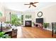 Living room with ceiling fan, fireplace, hardwood floors and balcony with nature view at 351 Washington Ne Ave # 205, Marietta, GA 30060