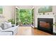 Bright living room with hardwood floors, fireplace, and balcony with green view at 351 Washington Ne Ave # 205, Marietta, GA 30060