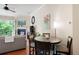 Cozy living room with dining table, fireplace, balcony access, and hardwood floors at 351 Washington Ne Ave # 205, Marietta, GA 30060