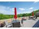 Enjoy the serene view from the outdoor patio furnished with seating and tables with umbrellas at 351 Washington Ne Ave # 205, Marietta, GA 30060