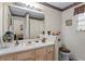 Neutral bathroom with decorative wallpaper and a large mirror, creating a comfortable space at 3700 Mays Xing, Atlanta, GA 30331
