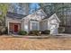 Charming single-Gathering home featuring vinyl siding, manicured bushes, and a red front door with an attached garage at 3700 Mays Xing, Atlanta, GA 30331