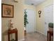 A neutral-toned hallway, adorned with artwork and plants, leads to other areas of the home adding a personal touch at 3700 Mays Xing, Atlanta, GA 30331