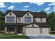 Charming two-story home with gray siding, black roof, stone accents, and a two-car garage at 4835 Beechnut Circle, Cumming, GA 30028