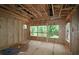 Interior framing of a sun-lit room showcases its potential, with views of the lush trees at 4835 Beechnut Circle, Cumming, GA 30028
