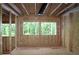 Framing stage with natural light from the windows offering a view of a lush green landscape at 4835 Beechnut Circle, Cumming, GA 30028