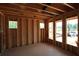Unfinished living room featuring wooden framing and natural light from multiple window openings at 4835 Beechnut Circle, Cumming, GA 30028