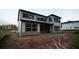 Rear of two-story new home construction featuring a large backyard, siding, and multiple windows at 4835 Beechnut Circle, Cumming, GA 30028