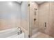Bathroom showing separate tub and shower with glass door and tiled walls at 905 Juniper Ne St # 708, Atlanta, GA 30309