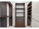 Walk-in closet features custom shelving and ample storage space with dark wood at 905 Juniper Ne St # 708, Atlanta, GA 30309