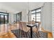 Elegant dining room with a modern table, upholstered chairs, and large windows at 905 Juniper Ne St # 708, Atlanta, GA 30309