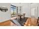 Stylish dining area with a dark table, beige chairs, and lots of natural light from the windows at 905 Juniper Ne St # 708, Atlanta, GA 30309