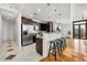 Modern kitchen with stainless steel appliances, dark cabinets, and a breakfast bar with stools at 905 Juniper Ne St # 708, Atlanta, GA 30309