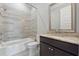 Well-lit bathroom featuring ceramic tile surround, undermount sink, and dark vanity at 1106 Briar Cove Cir, Atlanta, GA 30329