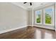 Bright bedroom featuring beautiful hardwood floors, a ceiling fan, and two large windows at 1106 Briar Cove Cir, Atlanta, GA 30329