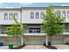 Exterior view of a modern townhome with attached garages and manicured landscaping at 1106 Briar Cove Cir, Atlanta, GA 30329