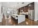 Open-concept kitchen features a large island, stainless steel appliances, and dark wood cabinets at 1106 Briar Cove Cir, Atlanta, GA 30329