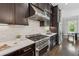 Kitchen with stainless steel range, white marble backsplash, and dark wood cabinets at 1106 Briar Cove Cir, Atlanta, GA 30329