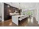 Spacious kitchen with a large marble island, pendant lighting, and dark wood cabinetry at 1106 Briar Cove Cir, Atlanta, GA 30329