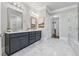 The main bathroom features a double vanity, decorative mirrors, and a glass shower at 1106 Briar Cove Cir, Atlanta, GA 30329