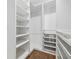 Spacious walk-in closet provides ample storage space with custom shelving and drawer systems at 1106 Briar Cove Cir, Atlanta, GA 30329