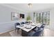 Elegant dining room with marble table, blue chairs, and modern decor at 3187 Abbeywood Dr, Decatur, GA 30034