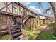 Back view of a townhome showcasing a patio on the second level, accessed by stairs at 3187 Abbeywood Dr, Decatur, GA 30034