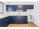 Kitchen featuring dark blue cabinets, white countertops, and stylish backsplash at 3187 Abbeywood Dr, Decatur, GA 30034