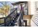 View of back deck with stairs leading to the yard, with lush trees in the background at 3193 Deshong Dr, Stone Mountain, GA 30087