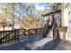 View of back deck with stairs leading to the yard, with lush trees in the background at 3193 Deshong Dr, Stone Mountain, GA 30087