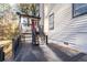 View of back deck with stairs leading to the yard, with lush trees in the background at 3193 Deshong Dr, Stone Mountain, GA 30087