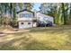 Back exterior view of the home featuring a large backyard and a second story deck at 3193 Deshong Dr, Stone Mountain, GA 30087