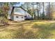 Back exterior view of the home featuring a large backyard and a second story deck at 3193 Deshong Dr, Stone Mountain, GA 30087