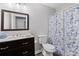 Bathroom featuring a dark vanity and mirror with a blue and white patterned shower curtain at 3193 Deshong Dr, Stone Mountain, GA 30087