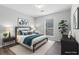 Comfortable bedroom with a large window providing natural light, complemented by stylish furnishings at 3193 Deshong Dr, Stone Mountain, GA 30087