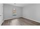 Bedroom featuring wood-look flooring, freshly painted walls, and a light-filled window at 3193 Deshong Dr, Stone Mountain, GA 30087