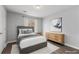 Neutrally decorated bedroom with a comfortable bed, a dresser, and a window with natural light at 3193 Deshong Dr, Stone Mountain, GA 30087