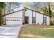 Charming single-Gathering home featuring a symmetrical front facade with a two-car garage and beautiful front yard at 3193 Deshong Dr, Stone Mountain, GA 30087