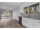 Bright kitchen boasts granite counters and stainless steel dishwasher overlooking a sunroom at 3193 Deshong Dr, Stone Mountain, GA 30087