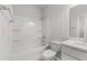 Bright bathroom featuring a shower-tub combo, modern sink and faucet, and toilet at 401 Village Ln, Fairburn, GA 30213