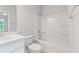 Bright bathroom featuring a shower-tub combo, modern sink and faucet, and toilet at 401 Village Ln, Fairburn, GA 30213