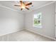 A cozy bedroom features neutral walls, carpet, a ceiling fan, and a bright window at 401 Village Ln, Fairburn, GA 30213