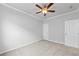 Cozy bedroom featuring neutral walls, soft carpet, ceiling fan, and white doors at 401 Village Ln, Fairburn, GA 30213