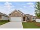 Charming one-story home featuring a brick facade, well-maintained lawn, and an attached two-car garage at 401 Village Ln, Fairburn, GA 30213