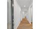 Bright hallway features wood flooring, white trim, and neutral paint, providing an open feel at 401 Village Ln, Fairburn, GA 30213