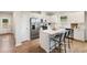 Modern kitchen features stainless steel appliances, white cabinets, quartz counters, and center island with seating at 401 Village Ln, Fairburn, GA 30213
