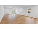 Spacious living room with wood flooring, natural light, ceiling fan, and neutral paint at 401 Village Ln, Fairburn, GA 30213
