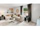 Inviting living room with plush sofa, stylish decor, and ample natural light at 401 Village Ln, Fairburn, GA 30213