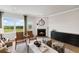 Bright living room with fireplace, hardwood floors, and large windows with scenic view at 401 Village Ln, Fairburn, GA 30213